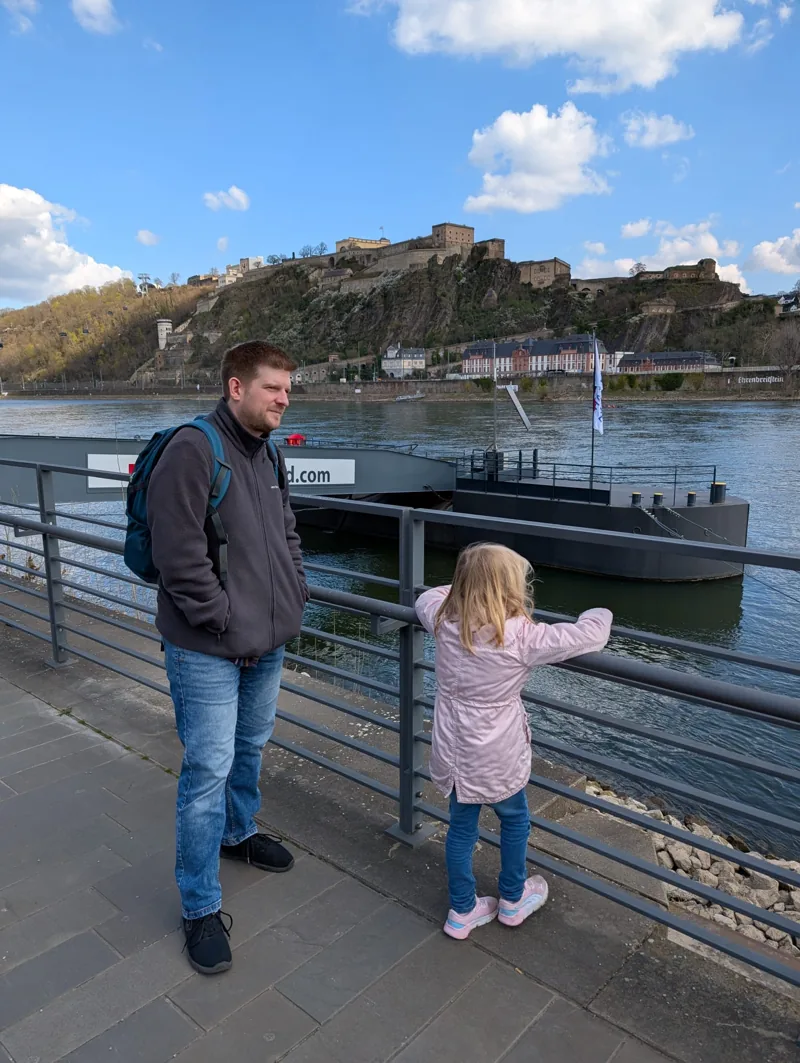 Tim with his daughter by the water, Ehrenbreitstein Fortress in the background